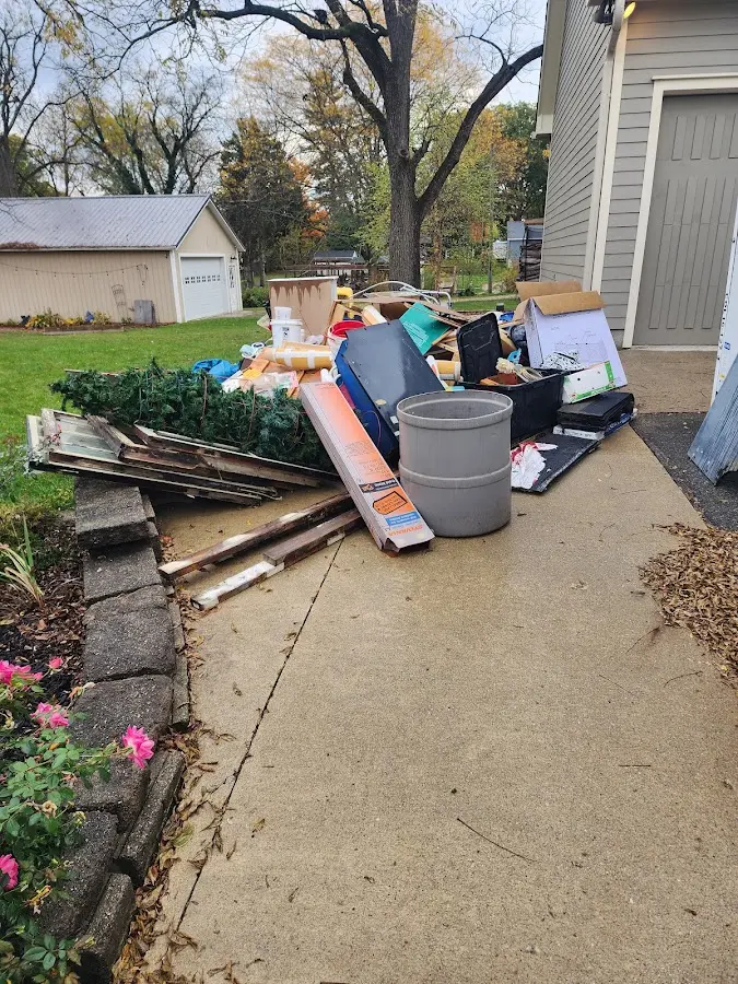 Dumpster being loaded with debris for 12 Yard Dumpster Rental in Buckhall